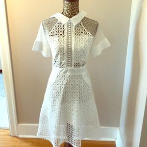 With lace dress with sheer cutouts.